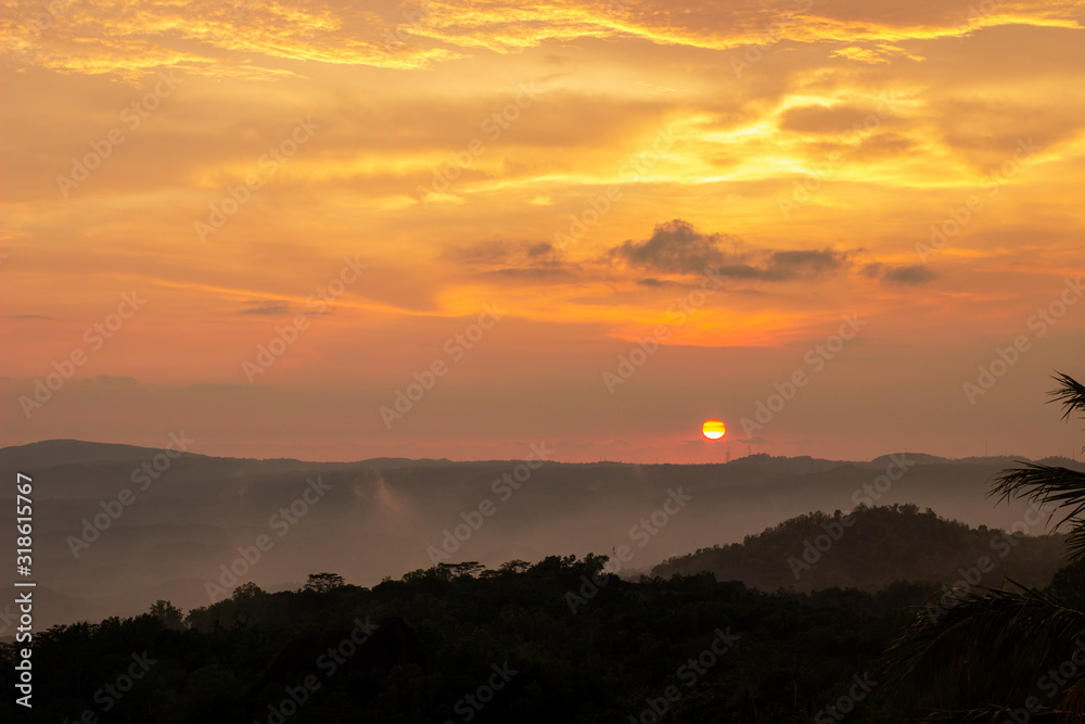 Obraz premium The sunset on Purba Volcano Mountain,Mount Api Purba. one of the tourist destination in Gunungkidul, Yogyakarta, Indonesia.