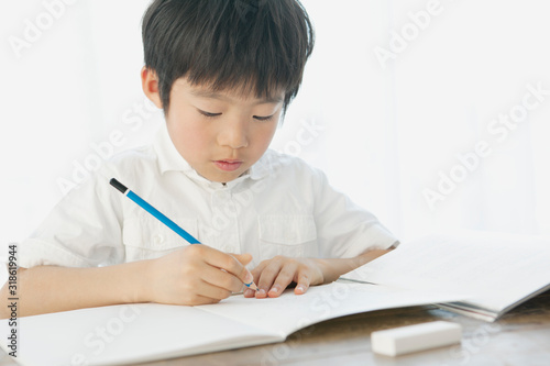 Boy writing in notebook photo