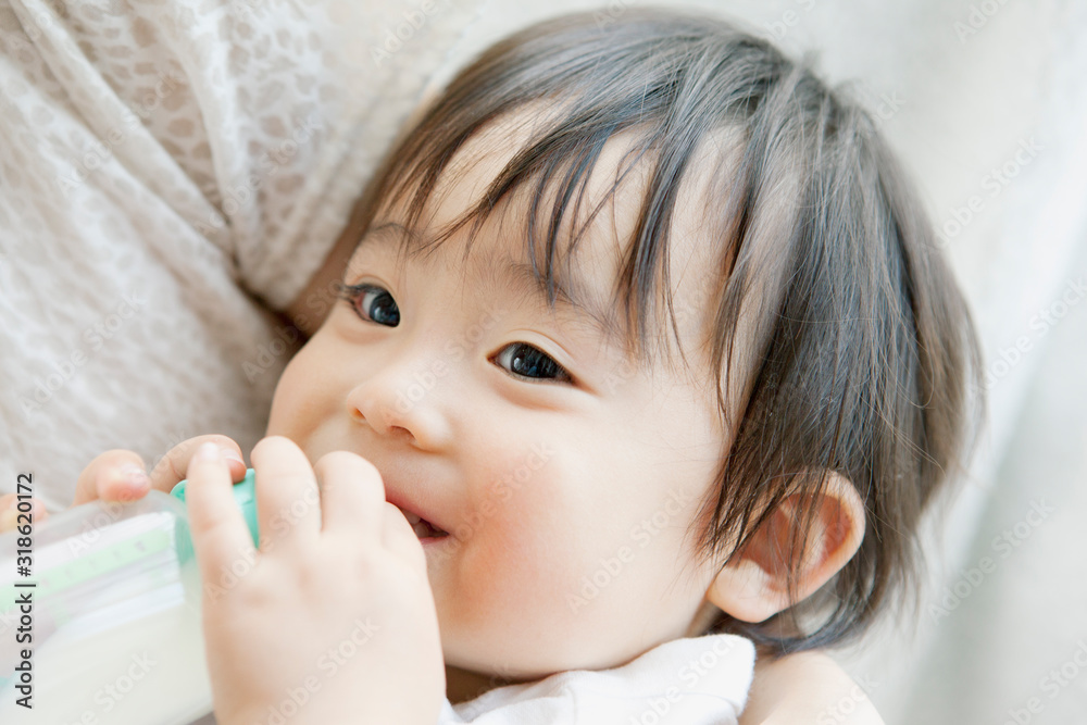 Close up of mother feeding son with bottle Close up of mother feeding son with bottle