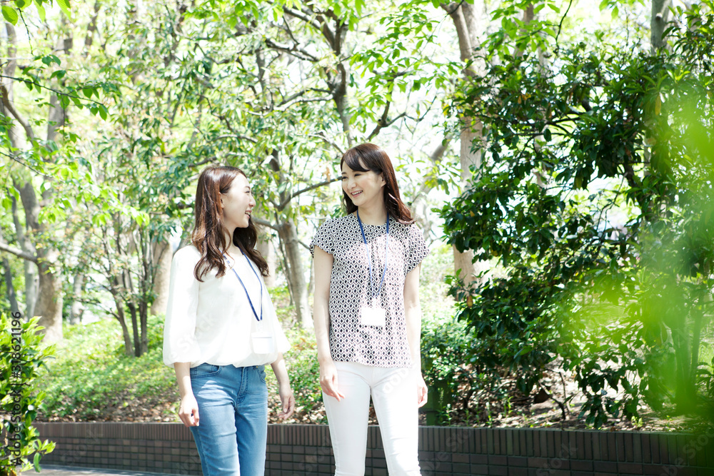 Two young women walking in park Two young women walking in park