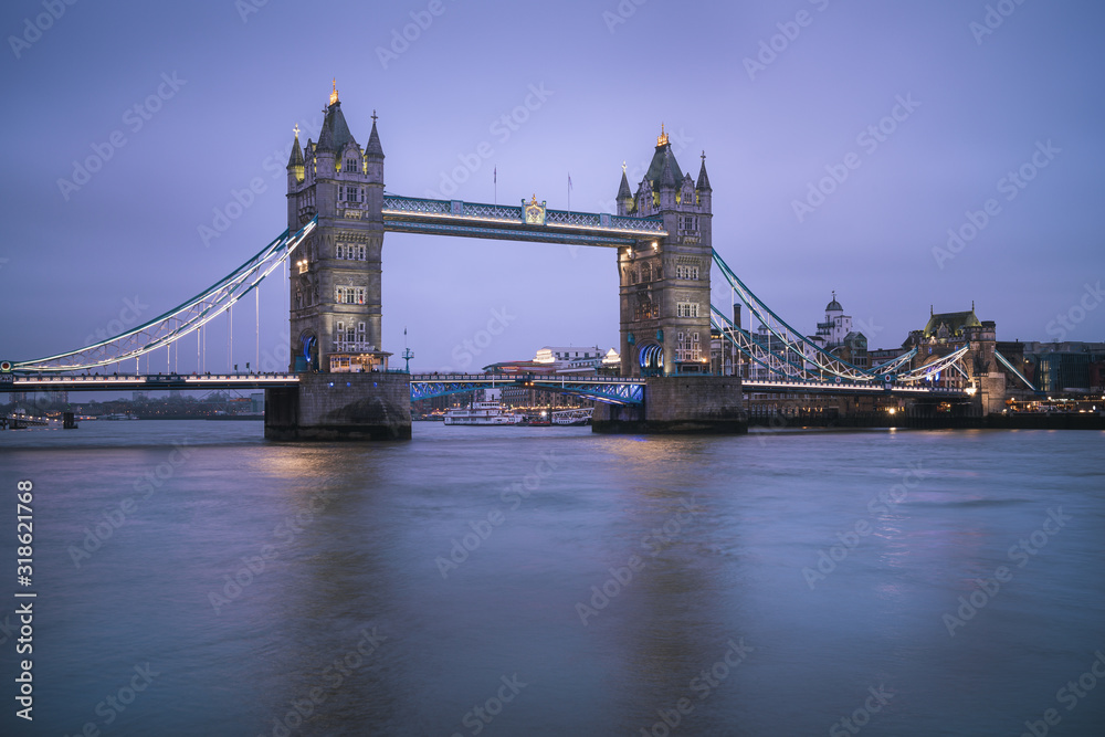 Perspective view of illuminated Tower Bridge during blue hour — London, United Kingdom