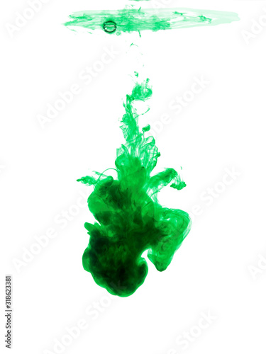 Abstract flowing fluid. Clouds of green color ink in water. Isolated on white background.