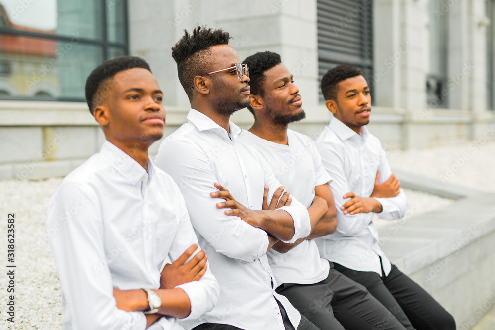 four handsome young african men in white shirts four handsome young african men in white shirts