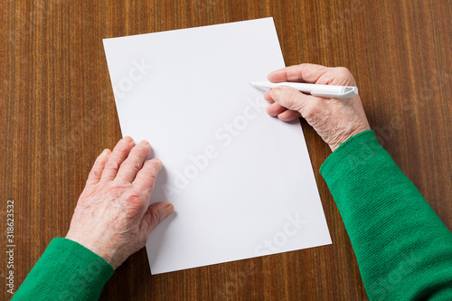 Old hands with blank paper