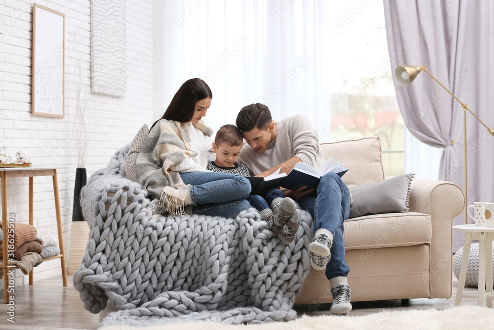 Happy family with little son reading books at home. Winter vacation Happy family with little son reading books at home. Winter vacation