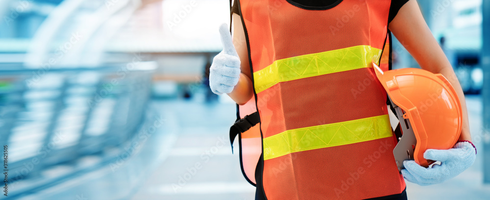 Asian construction worker thumbs up And carrying a yellow helmet wearing worker clothes. Standardized working equipment And safe for workers. Choosing mechanic equipment. banner of copy space Asian construction worker thumbs up And carrying a yellow helmet wearing worker clothes. Standardized working equipment And safe for workers. Choosing mechanic equipment. banner of copy space