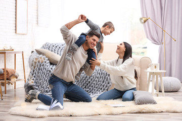 Happy family with little son having fun at home. Winter vacation