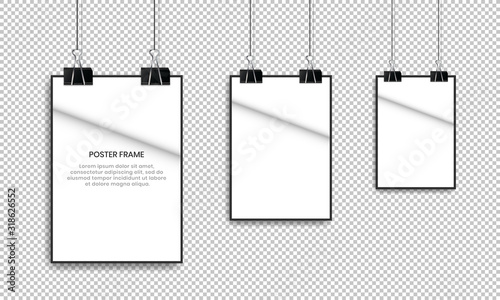 Blank white poster hanging with binder clips.