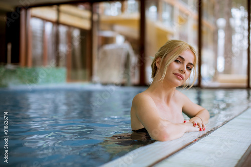 Young woman relaxing in spa swimming pool