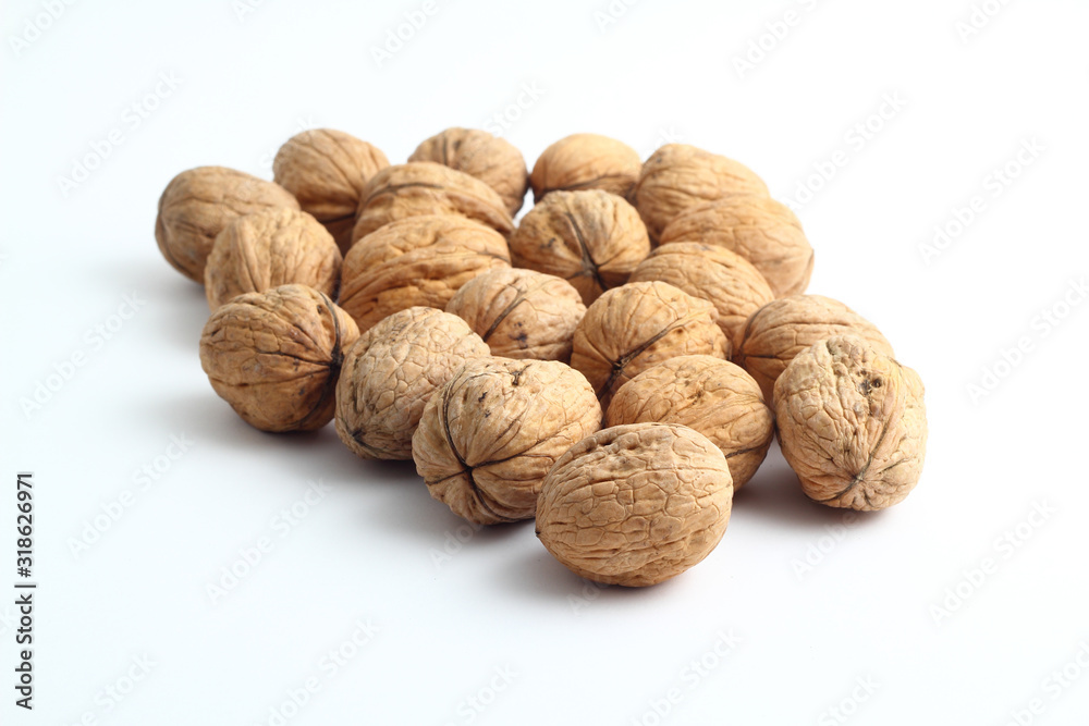 Peeled walnut closeup. Golden walnut kernel on a white background. Healthy foods. Peeled walnut closeup. Golden walnut kernel on a white background. Healthy foods.