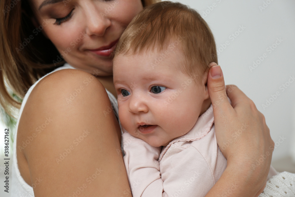 Young woman with her little baby resting after breast feeding at home, closeup Young woman with her little baby resting after breast feeding at home, closeup