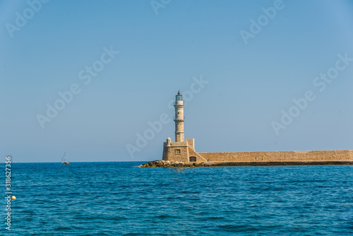  CHANIA, GREECE - THE OLD VENETIAN HARBOUR AND THE LIGHTHOUSE OF CHANIA. SUNNY SUMMER DAY IN CHANIA, GREECE