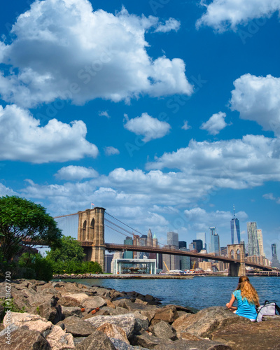 Fototapeta Naklejka Na Ścianę i Meble -  solitary woman's skyline perspective of Manhattan from Brooklyn