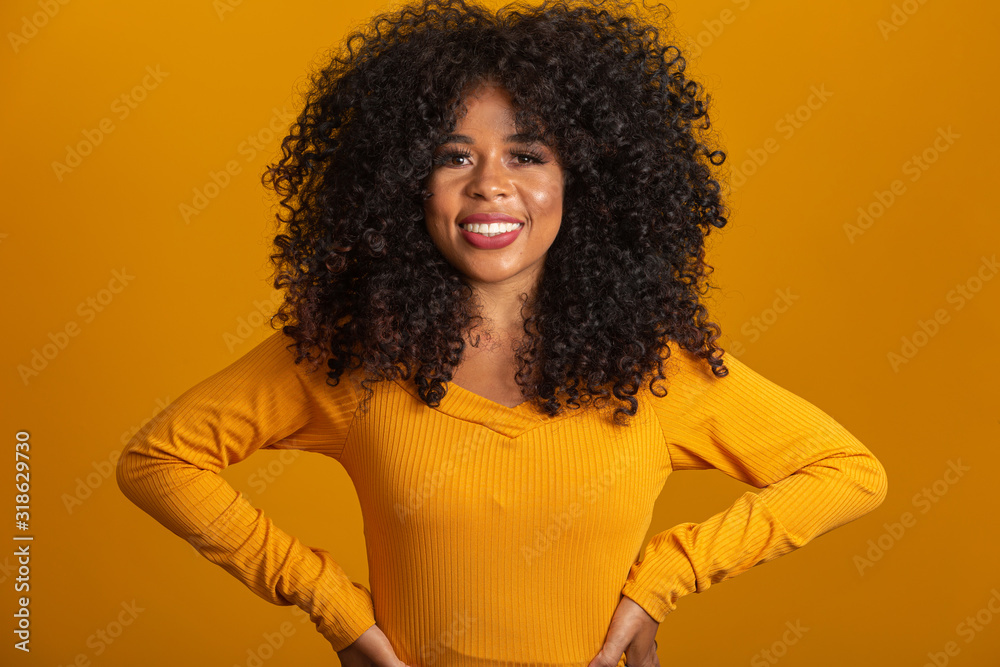 Young afro-american woman with curly hair looking at camera and smiling. Cute afro girl with curly hair smiling looking at camera. Young afro-american woman with curly hair looking at camera and smiling. Cute afro girl with curly hair smiling looking at camera.
