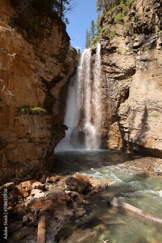 Rivers and waterfalls with pine tree forests and summits in the Rocky Mountains in Canada, British Columbia, West coast