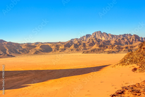 Aerial view of valley landscape of Wadi Rum Desert and Valley of the Moon in the afternoon, southern Jordan. Popular tourist destination for spectacular sandstone and granite rock.