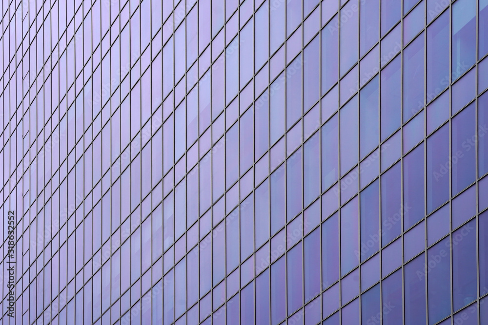 Glass blue square Windows of facade modern city business building skyscraper. Modern apartment buildings in new neighborhood. Abstract architecture. Windows of a building, texture.  