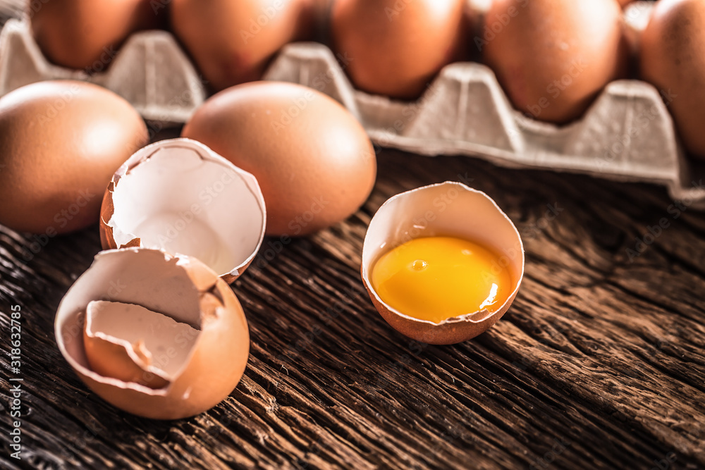 Fresh raw eggs on rustic wooden table - Top of View Fresh raw eggs on rustic wooden table - Top of View