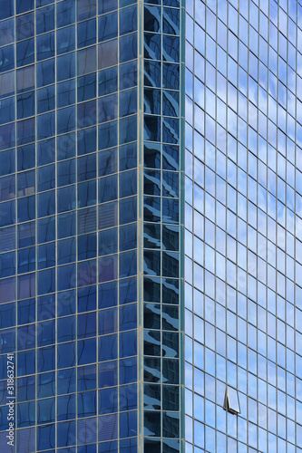 Abstract architecture. Glass blue square Windows of facade modern city business building skyscraper. The texture of the windows of the building. 