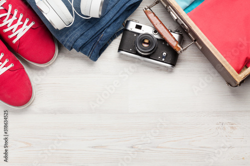 Suitcase, camera, clothes and travel accessories