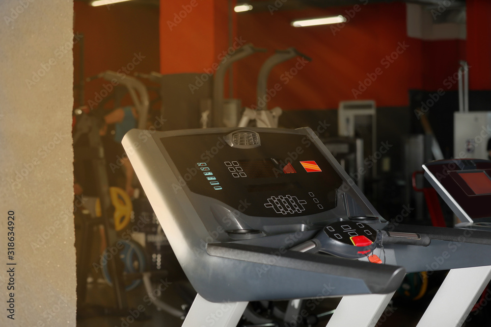Black treadmill in gym. Modern sport equipment