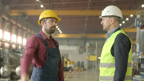 Factory empoyee giving report to his boss