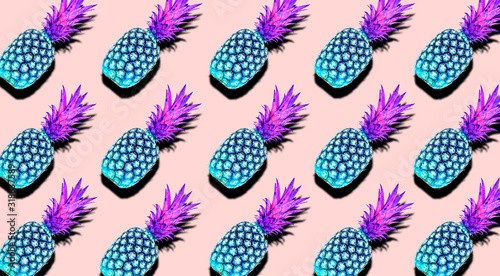 Creative pattern of fruit pineapples unusual blue and pink colors with shadows on a soft pink color summer background. Clipping Path.