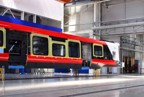 Inside of the rail car assembly plant. Industrial workshop for the production of high speed trains. Factory of the manufacturing trainsets passenger rolling stock. Paint shop