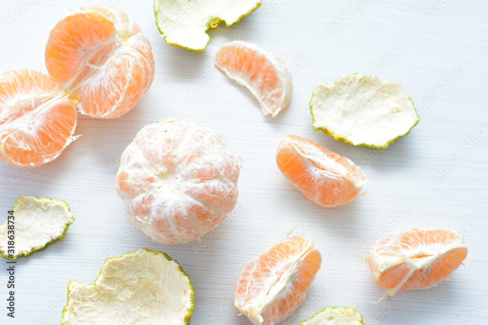  Natural, whole, chopped tangerines on wooden background