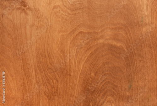 Texture of stained brown plywood with wooden rings