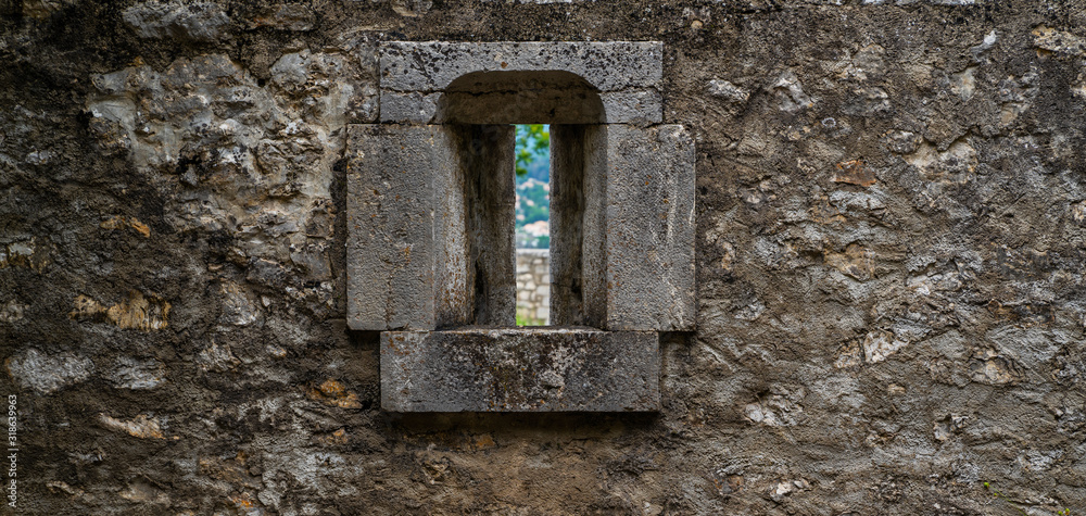 Medieval old stone castle wall with metal forging. Antique stone wall with traces of weathering and destruction. Medieval old stone castle wall with metal forging. Antique stone wall with traces of weathering and destruction.
