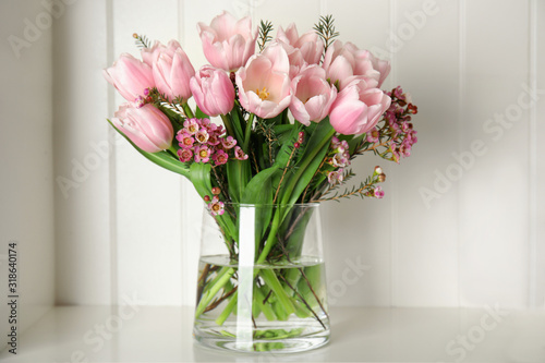 Beautiful bouquet with spring pink tulips on shelf