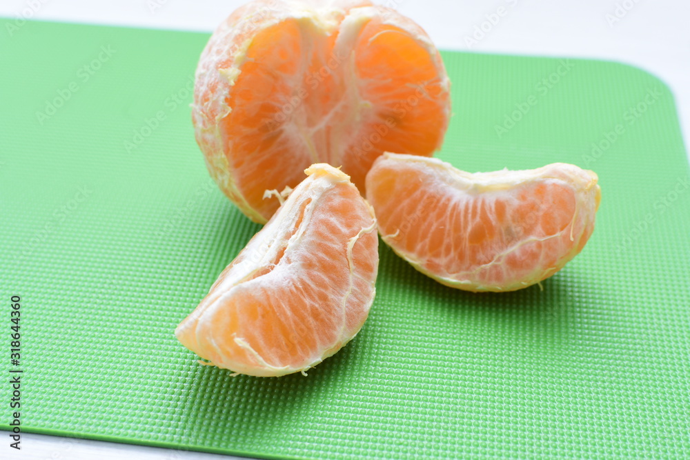 Natural, whole, chopped tangerines on wooden background Natural, whole, chopped tangerines on wooden background