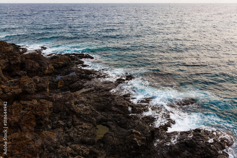 ocean waves hit and crash against stones ocean waves hit and crash against stones