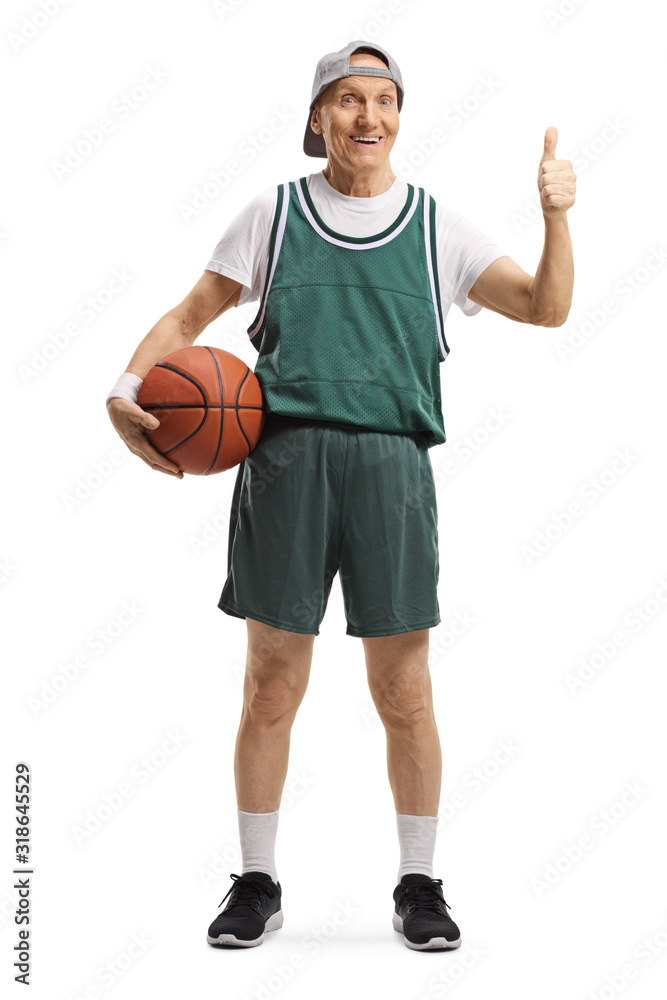 Senior man in a green jersey holding a basketball and showing thumbs up