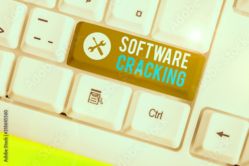 Writing note showing Software Cracking. Business concept for modification of software to remove or disable features photo