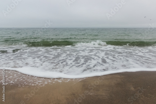 wave on the cloudy beach 