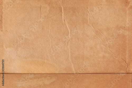 Texture of brown paper with streaks and spots