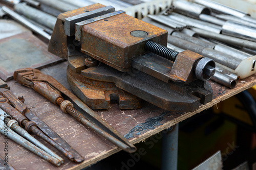 Vise and various tools on a workbench