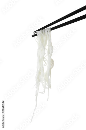 Chopsticks with tasty cooked rice noodles isolated on white