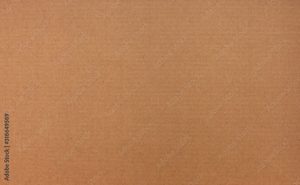 Texture of brown recycled corrugated cardboard with small inclusions Texture of brown recycled corrugated cardboard with small inclusions