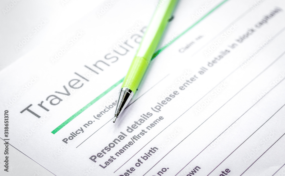 Traveling concept with insurance application on white table Traveling concept with insurance application on white table