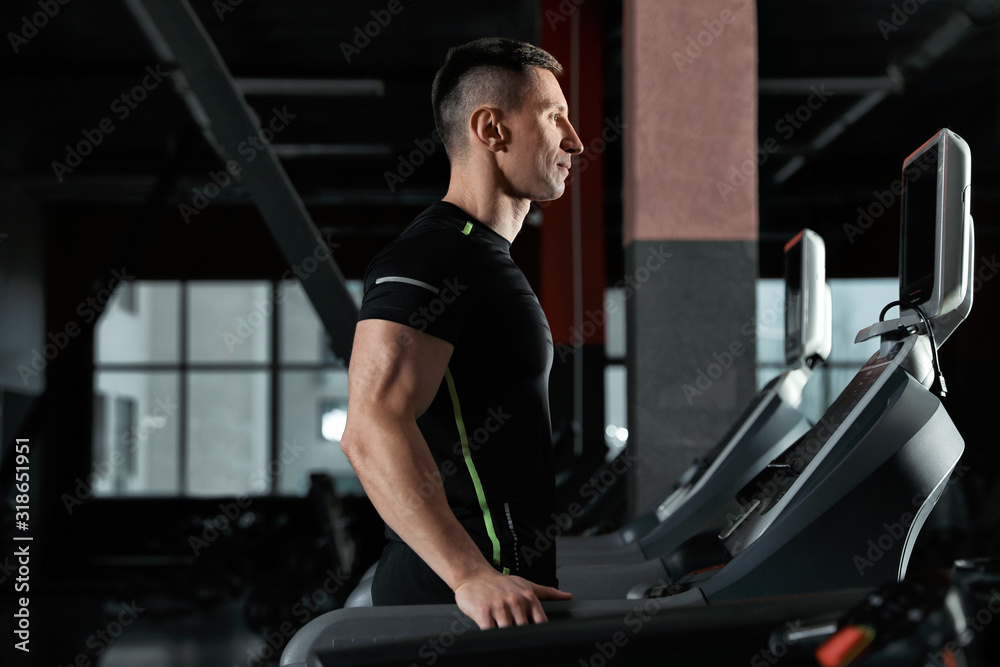 Man working out on treadmill in modern gym Man working out on treadmill in modern gym