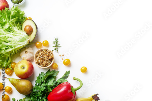 Various healthy raw organic vegetables  herbs  sprouts and fruits isolated on white background. Top view vegetarian food with copy space