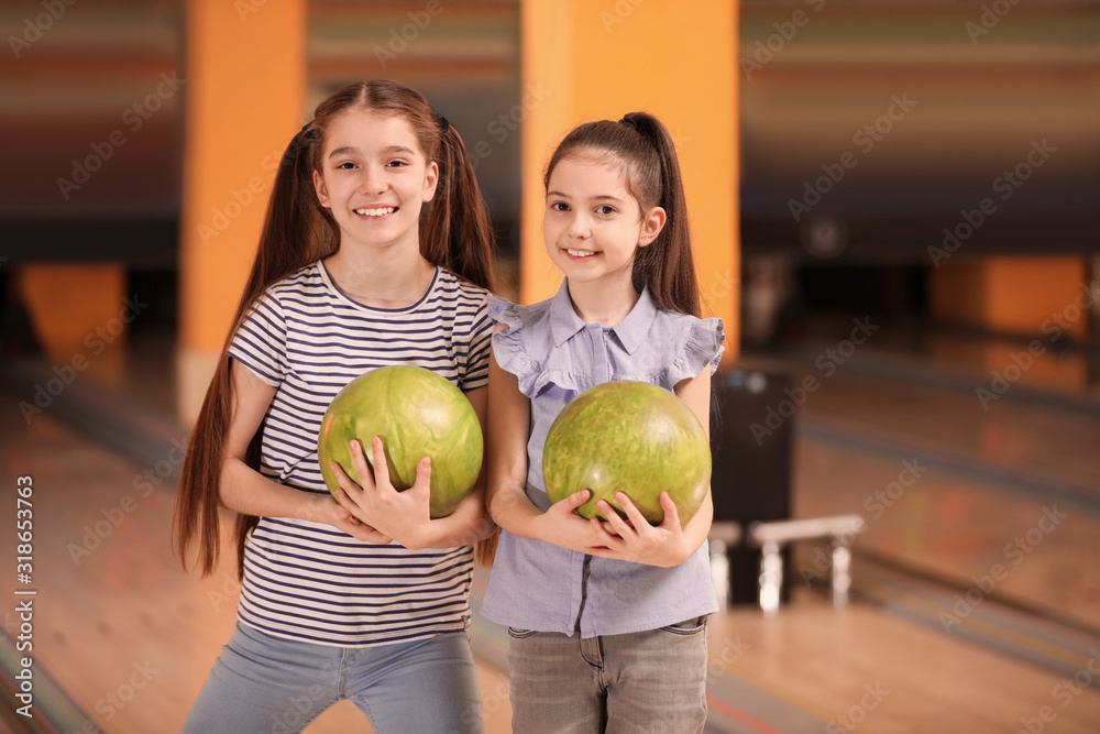 Fototapeta premium Happy girls with balls in bowling club