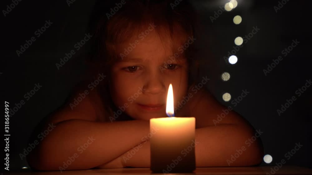 Candle in the dark and the little girl. Candle in the dark and the little girl.