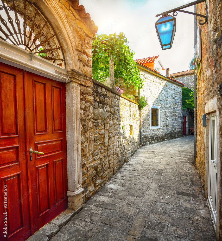 Fototapeta premium Old Town Citadela with paved narrow street in the Budva city.
