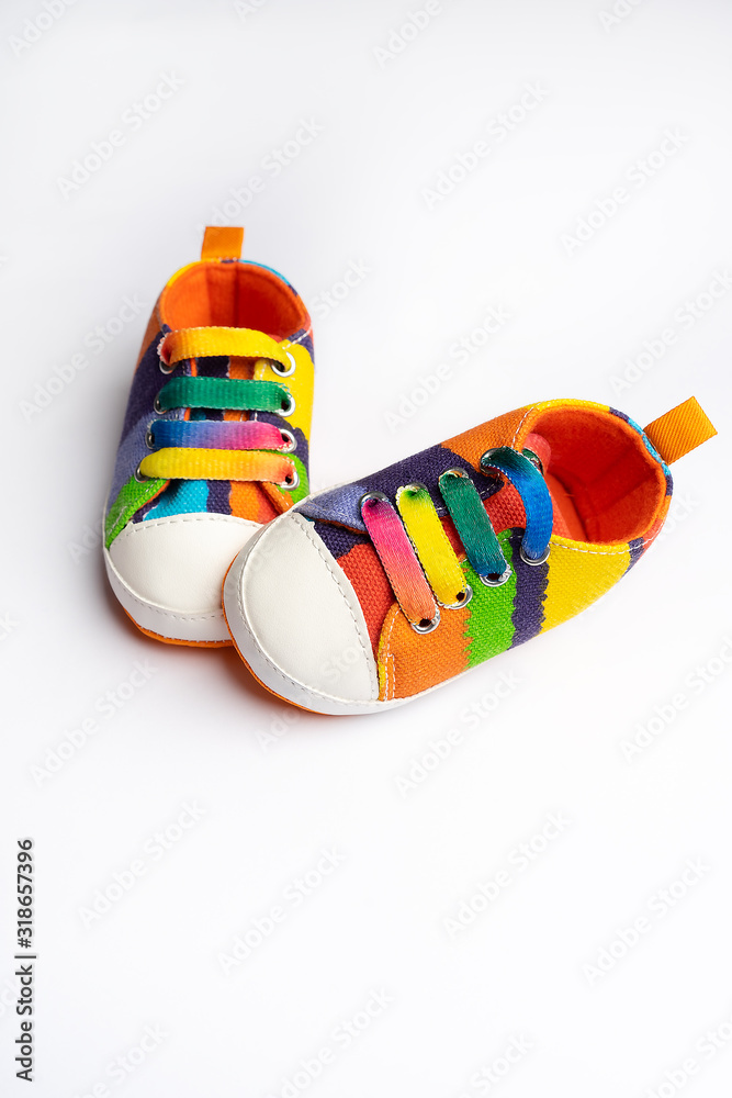 Denim sports shoes for baby, stands on a white background. The concept of children's clothing. 