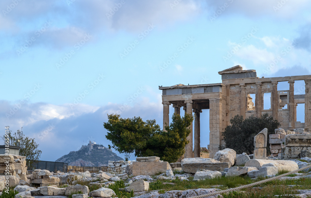 Ancient Erechtheion temple on Acropolis hill in Athens, Greece with pillars and statues, soft focus.