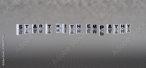 start with empathy concept represented by wooden letter tiles